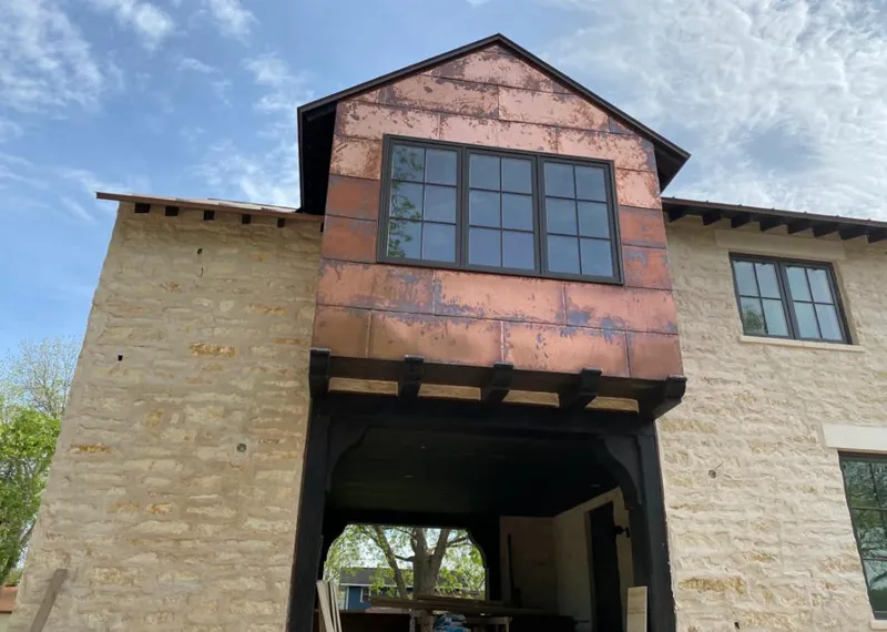 Copper metal panel facade on a stone building for Skylight Installation in Wadsworth